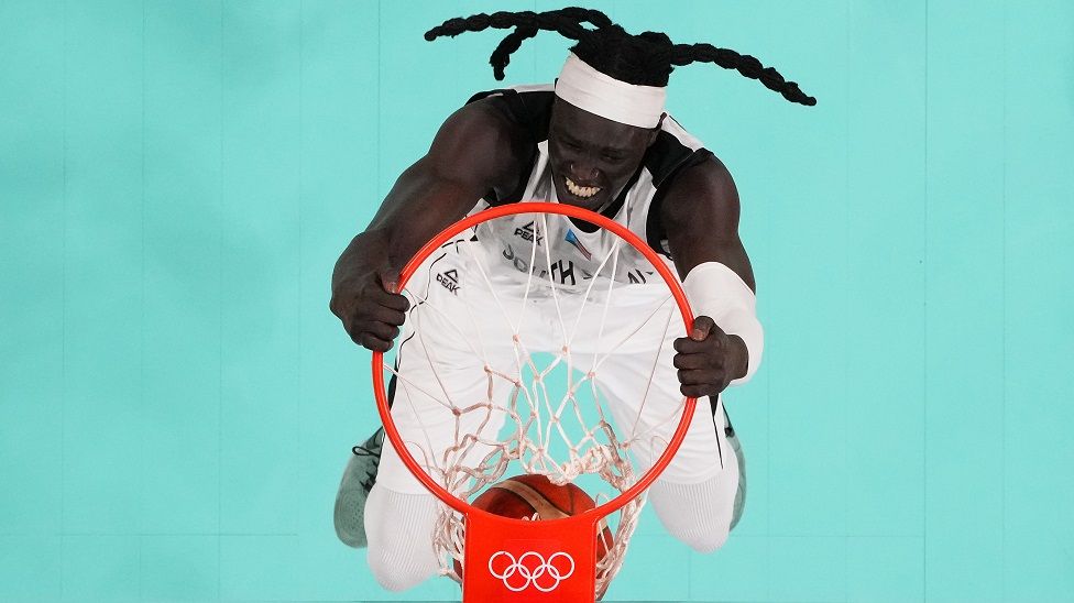 Olympic South Sudan team member dunking in the olympic games 2024