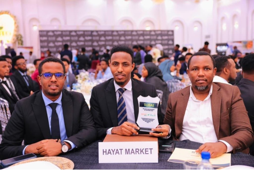 Hayat Market representatives and guests gather with the trophy after the awards presentation. Photo: Supplied